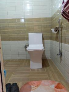 a bathroom with a toilet in a shower stall at Jungle Nirvana Retreat in Meghauli