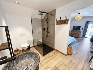 a bathroom with a shower and a bedroom at Le petit refuge in Allos