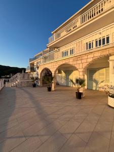 a large building with potted plants in front of it at Guest House Life in Neum