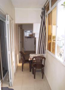 a dining room with a table and two chairs at Duplex T3 résidence Djnen el Bey in Annaba