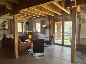 a living room with a couch and a table at Au bord du lac IV in Montigny-en-Morvan