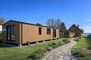 a tiny house is shown on a yard at EkoOazy nad Jeziorem in Firlej