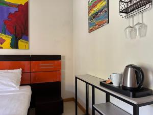 a bedroom with a bed and a desk with a coffee maker at Casaliva Relais in Bardolino