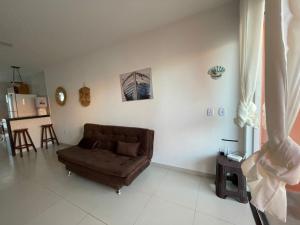 a living room with a brown couch in a room at Cantinho Jauá 3 in Camaçari