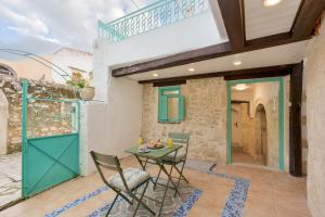 a room with a table and chairs and a balcony at Villa Amanda by CVR in Roústika