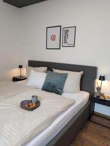 a bed with a tray of food on top of it at Ferienwohnung Strizi inkl Chiemgau Karte in Ruhpolding