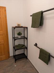 a black towel rack with towels on a wall at Ferienwohnung Strizi inkl Chiemgau Karte in Ruhpolding +25 photos