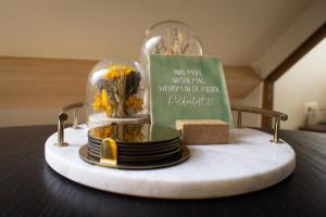 a cloche with plates and flowers in it on a table at Polderloft 27 in Hengstdijk