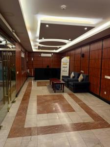 a lobby with couches and a table in a building at واحة الاحساء للشقق المخدومة in Al Hofuf