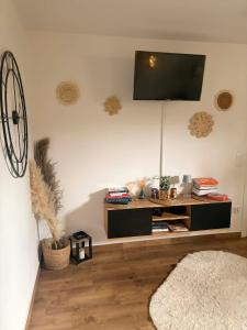 a living room with a flat screen tv on the wall at Dolina Świtu in Pokrzywna