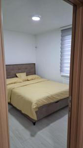 a bedroom with a bed in a white room at Quiet apartment in Hadžići