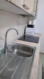 a kitchen counter with a sink and a sink at Quiet apartment in Hadžići +51 photos