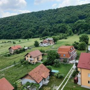 an aerial view of a village with houses and a hill at Quiet apartment in Hadžići