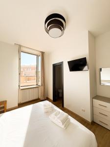 a bedroom with a large white bed and a window at Le Tre Lune Rooms in Matera