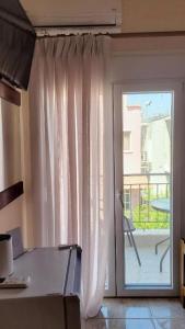 a room with a sliding glass door to a patio at Sundive Apartments in Limenas