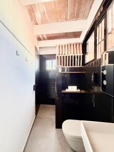 a bathroom with a toilet and a sink at TarifaMiCasa Amor de Dios in Tarifa +20 photos