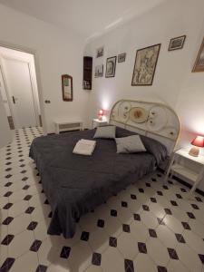 a bedroom with a large bed with a black blanket at Sunset House in Santa Marinella