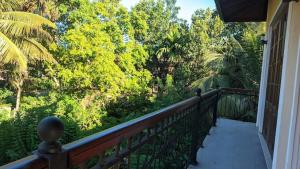 a balcony of a house with a view of trees at Arora Villa in Digana
