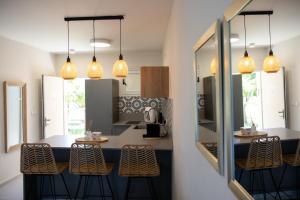 a kitchen with a counter with stools in it at Liz suite in Caesarea