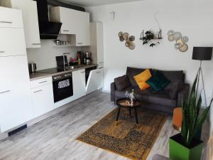 a living room with a couch and a table in a kitchen at Evia Ferienwohnung in Heimbach