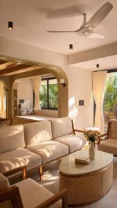 a living room with a couch and a table at The Elysian Morjim 150 Meters to Morjim Beach in Morjim +41 photos
