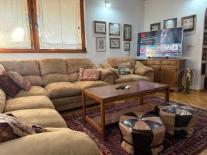 a living room with a couch and a coffee table at Villa Solis Sarajevo Private Pool Jacuzzi in Sarajevo
