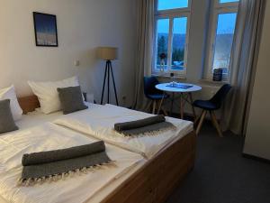 a bedroom with a large bed with two pillows on it at Alte Harcher Schule in Harra