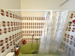 a bathroom with a tub and a shower curtain at Radio House in Myrina +23 photos