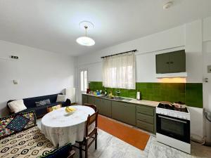 a kitchen with a table and a couch in a room at Radio House in Myrina
