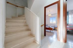 a staircase in a living room with a mirror at Hauzify I Casa Arboç in Platja d'Aro +18 photos