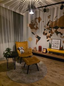 a room with a chair and a map on the wall at Loft Haven - Loftowa Przystań in Trzemeszno