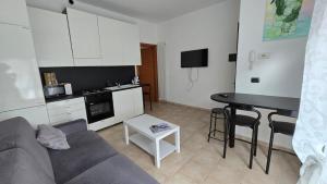 a living room with a couch and a table at Faraboni Apartments in Novara +10 photos