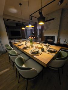 a long table in a room with chairs around it at Loft Haven - Loftowa Przystań in Trzemeszno