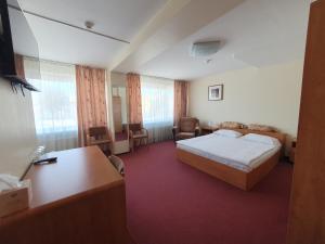 a hotel room with a bed and a desk at Hotel Madona in Madona +93 photos