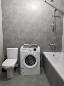 a bathroom with a washing machine and a toilet at Lux na Druhetiv in Uzhhorod +36 photos