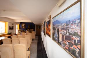 a row of chairs in a room with pictures on the wall at Hotel Ferijalac in Sarajevo