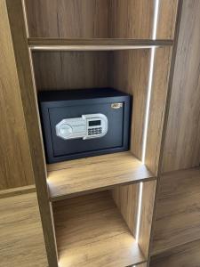 a small tv in a wooden book shelf at Vila Llaman Luxury Rooms in Himare
