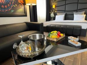 a living room with a couch and a bed at City One Hotel in Kayseri
