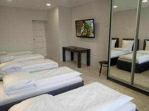 a room with several beds and a mirror at Lux na Druhetiv in Uzhhorod
