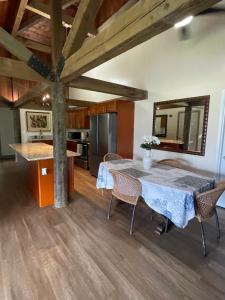 a kitchen and dining room with a table and chairs at Kaena O Kekai in Hauula +6 photos