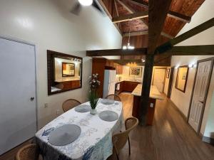 a dining room with a table and chairs and a kitchen at Kaena O Kekai in Hauula