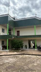 a building with a motorcycle parked in front of it at Hotel R Soares 2 in Carutapera