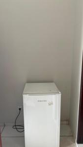 a white refrigerator in the corner of a room at Hotel R Soares 2 in Carutapera
