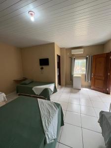a hospital room with two beds and a tv at Hotel R Soares 2 in Carutapera