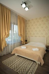 a bedroom with a bed and a large window at Vila Medana- Neamt in Humuleşti