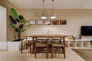a dining room with a wooden table and chairs at Impressive beachfront home in Calafell