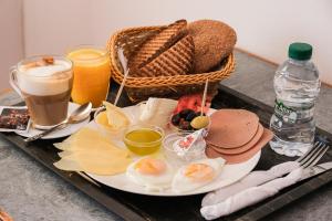 a tray with eggs and bread and drinks on a table at Hotel Fnidaq in Fnidek