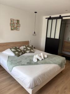a bedroom with a large bed with two pillows at La Claverie in Cholet