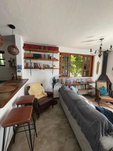 a living room with a couch and a chair at Casa na "Villa Grega" pertinho do Parque Nacional, Feirinha do Alto e Granja Comary in Teresópolis