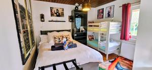 a bedroom with a bed and a bunk bed at B&B immersif La Chambre de Ratatouille 10 min Disney in Isles-lès-Villenoy
